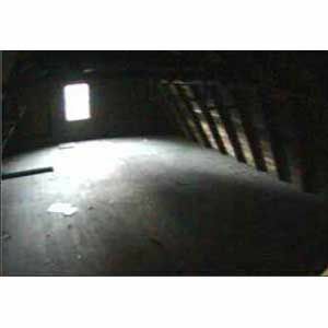 < p> Em julho, a vista do topo das escadas mostrava que o piso do loft do antigo celeiro era um espaço escuro, apertado e completamente pouco convidativo. O teto baixo oferecia muito pouco espaço, mas as leis de zoneamento Concord impediam os proprietários de elevar o telhado. </p>