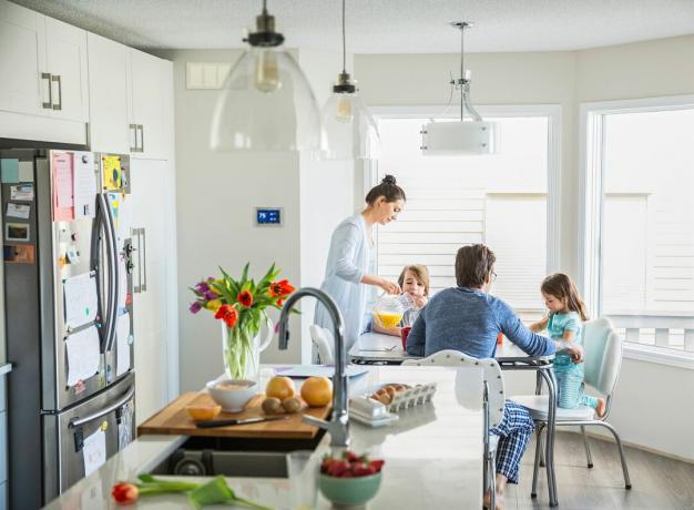 Ģimene ēd virtuvē, kurā ir zonēts sistēmas gaiss